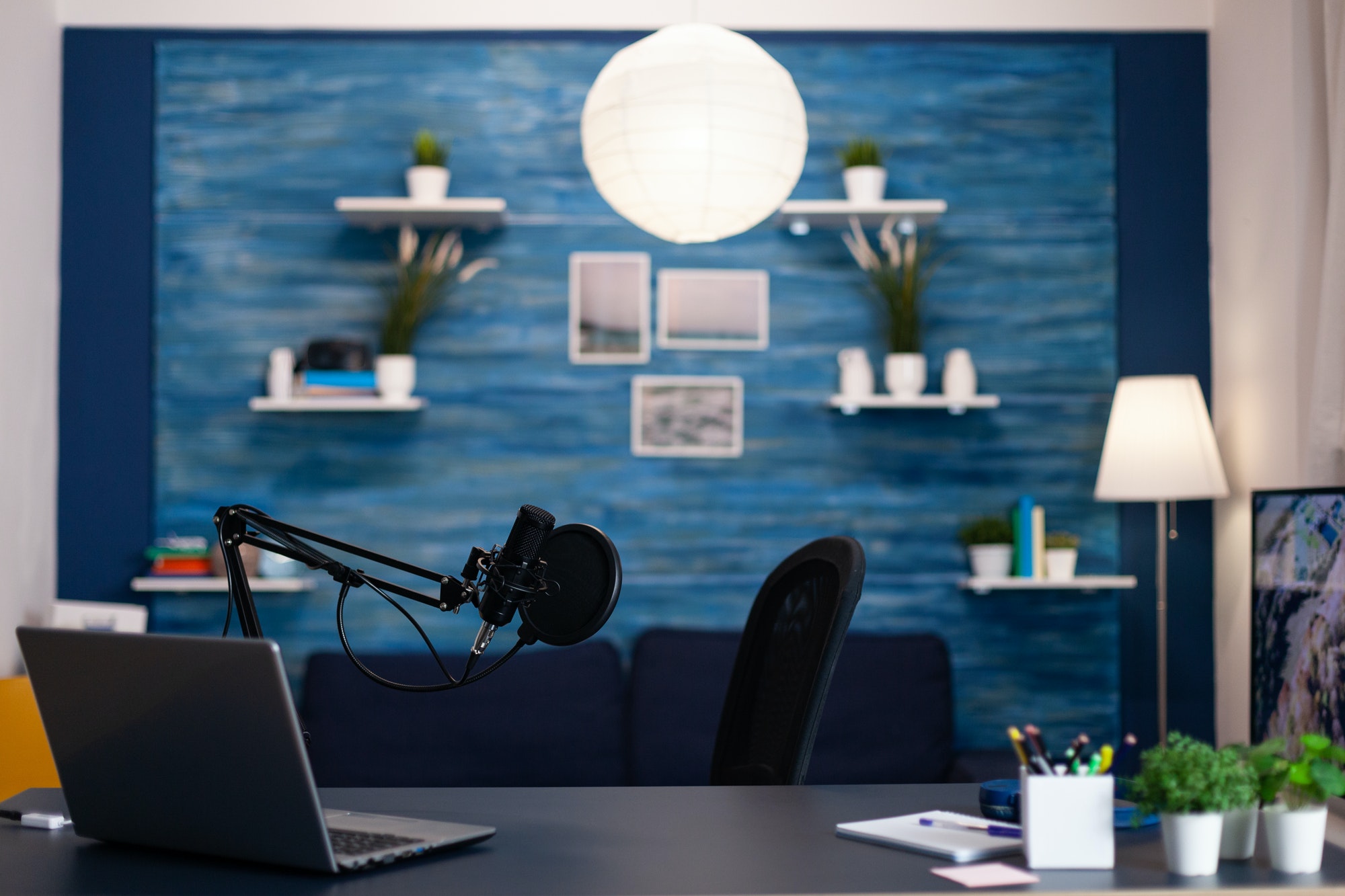 Empty podcast studio with nobody in it equipped with professional production podcasting equipment